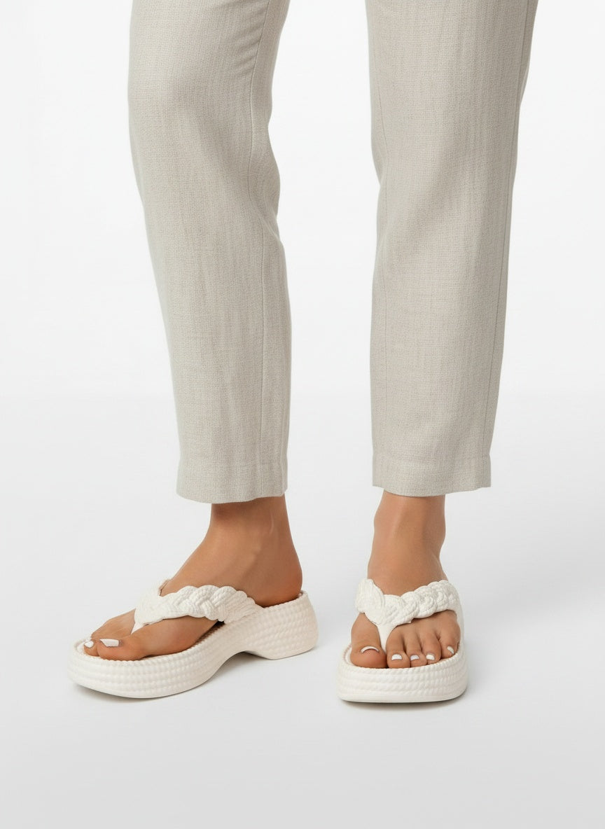 Close-up lower legs and shoes of the model wearing Gevlochten Plateau Slippers met Zachte Zool