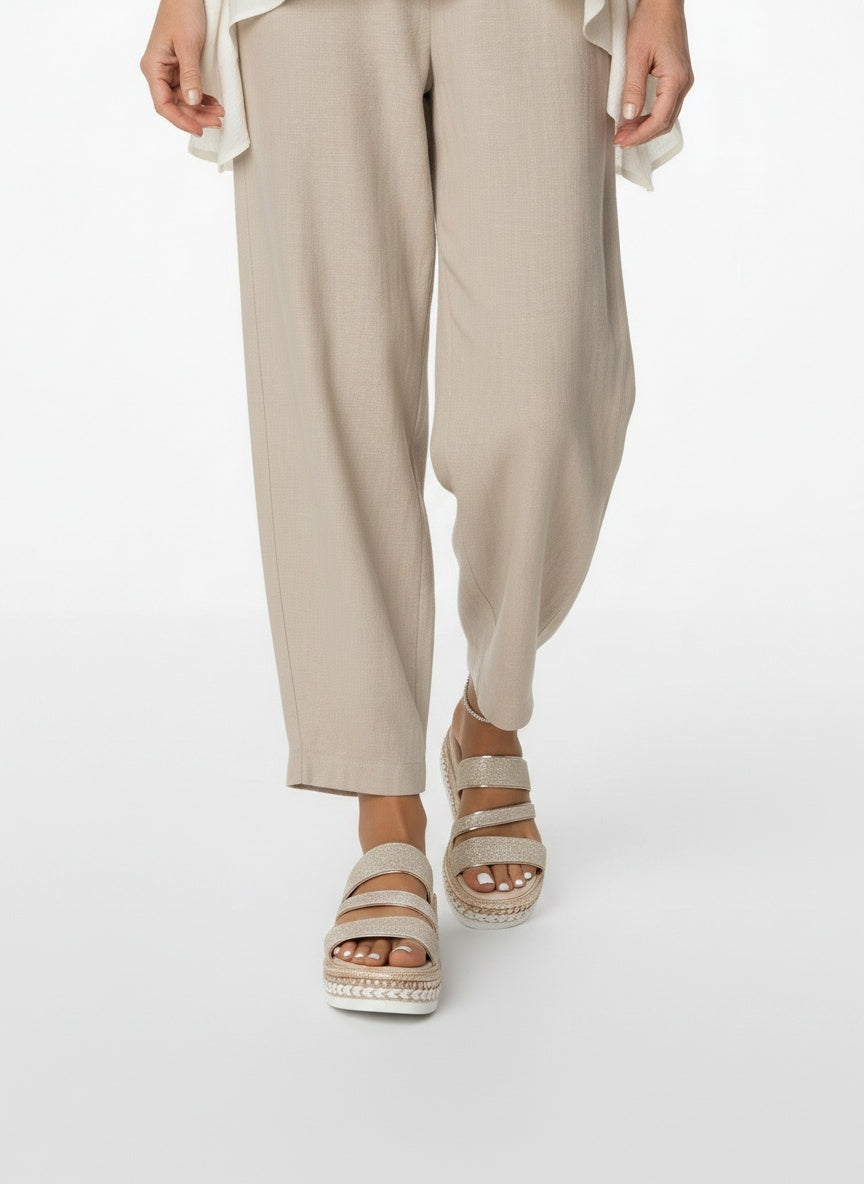 Close-up lower legs and shoes of the model wearing Glitter Sandalen met Gevlochten Plateauzool